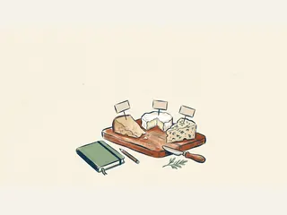 Tres tipos de queso sobre una tabla se acompañan de un cuaderno y un cuchillo de servicio.