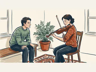 Una persona adulta toca el violín mientras otra escucha en una habitación.