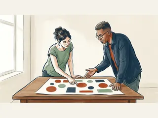 Dos personas adultas consultan una lámina educativa con círculos y rectángulos.