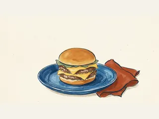 Hamburguesa con dos piezas de carne y dos lonchas de queso sobre un plato azul.
