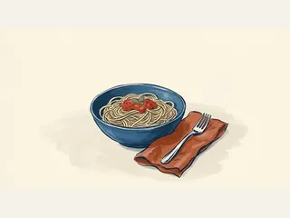 Cuenco azul con espaguetis y salsa de tomate junto a un tenedor.