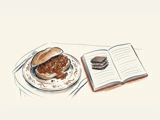 Un panecillo de carne picada en salsa aparece junto a un cuaderno con la variante de sándwich de centeno.